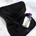 A soft black after-sex towel with a lubricant, ready for Post-Intimacy clean-up.