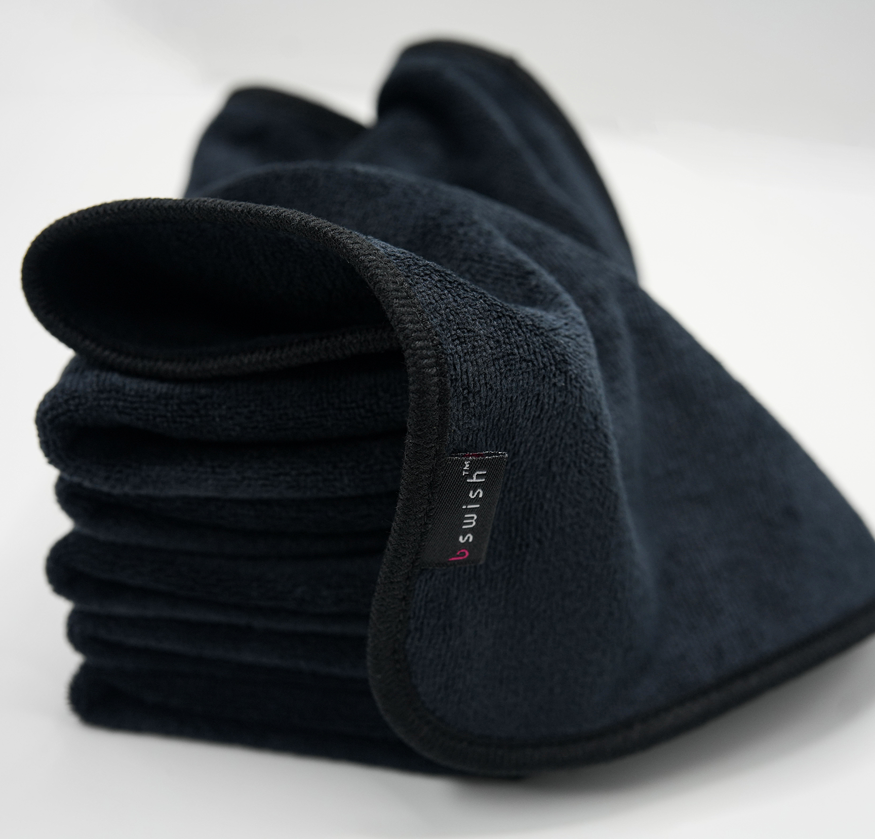 A soft black after-sex towel neatly stacked, ready for Post-Intimacy clean-up.